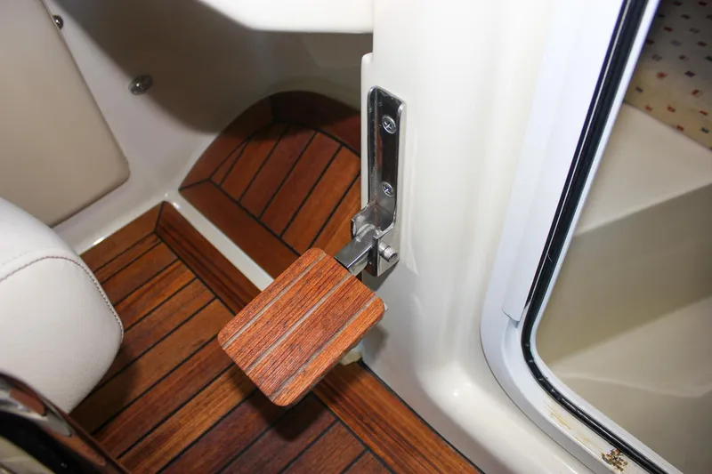 Slide: The Image of 2011 Chris-Craft Corsair 28 interior with beige seating and wooden flooring. - 56