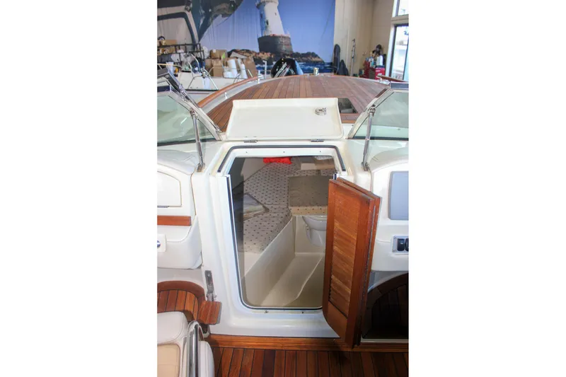 Slide: The Image of 2011 Chris-Craft Corsair 28 boat interior with Garmin navigation system and wooden accents. - 57