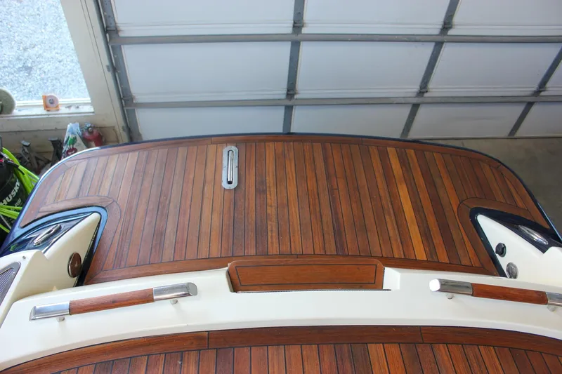 Slide: The Image of 2011 Chris-Craft Corsair 28 with wooden deck in a boat showroom. - 58