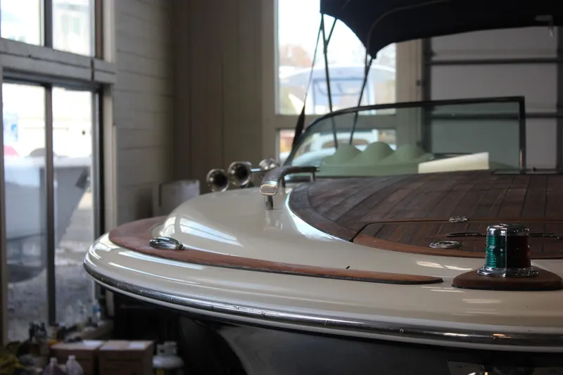 Slide: The Image of 2011 Chris-Craft Corsair 28 dashboard with Garmin navigation and classic wooden steering wheel. - 59