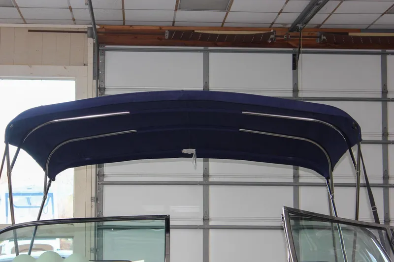 Slide: The Image of 2011 Chris-Craft Corsair 28 boat with wooden deck in indoor storage. - 7