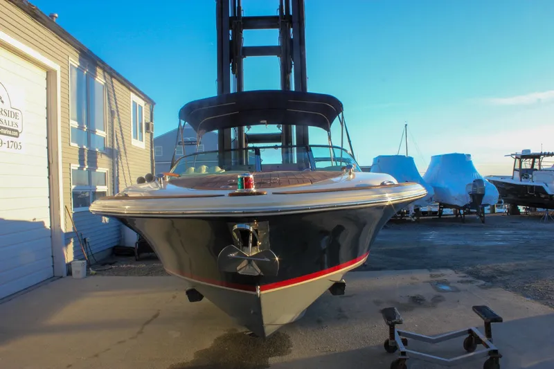Slide: The Image of 2011 Chris-Craft Corsair 28 boat docked at a marina under clear blue skies. - 72