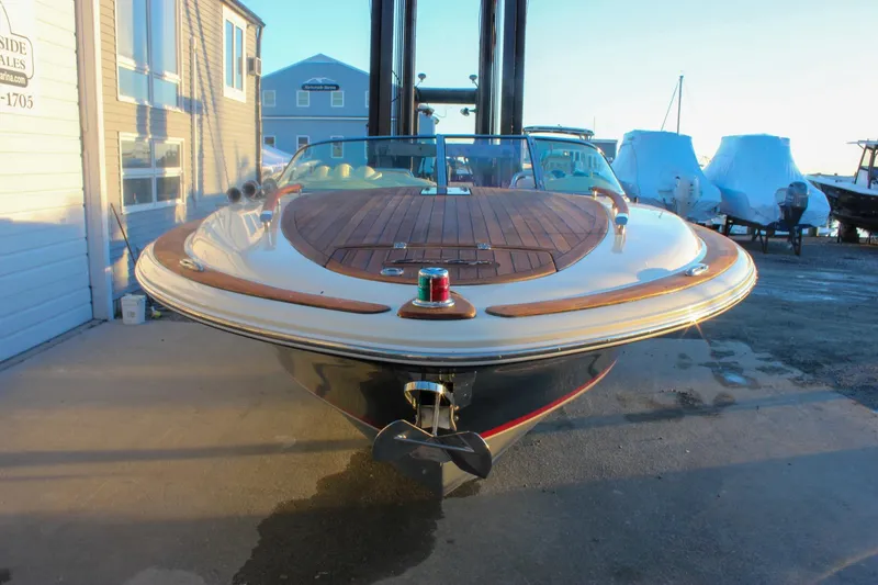 Slide: The Image of 2011 Chris-Craft Corsair 28 boat with wooden deck, docked at marina. - 80