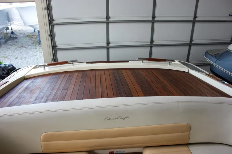 Slide: The Image of 2011 Chris-Craft Corsair 28 boat in a garage, front view with anchor. - 9