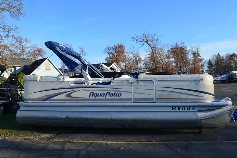The Image of 2004 AquaPatio 22 pontoon boat parked on a sunny day. - 0