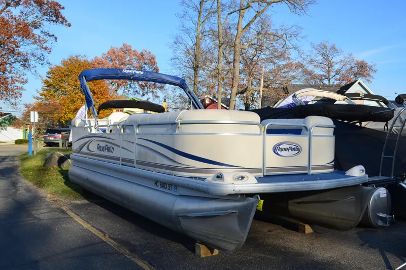 Slide: The Image of 2004 AquaPatio 22 pontoon boat parked on a sunny autumn day. - 1