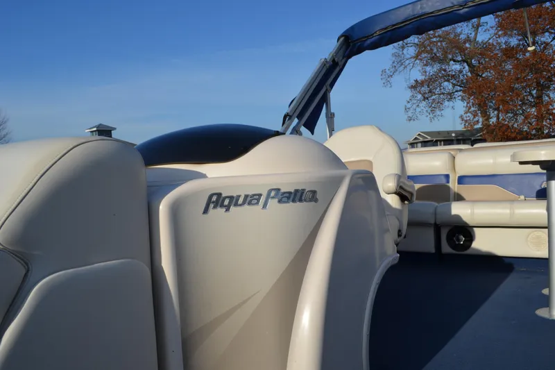Slide: The Image of 2004 AquaPatio 22 pontoon boat interior with seating and clear blue sky. - 10