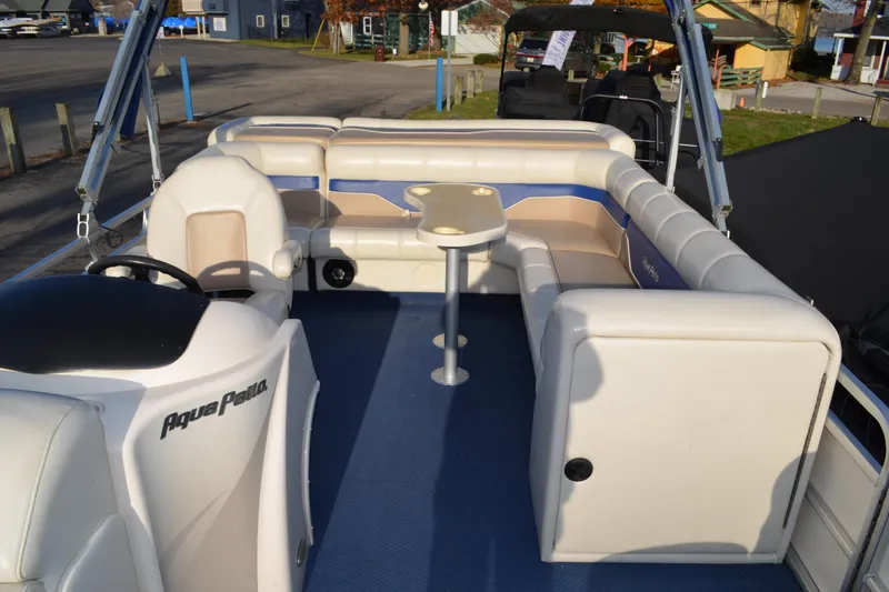 Slide: The Image of 2004 AquaPatio 22 pontoon boat interior with seating and steering console. - 11