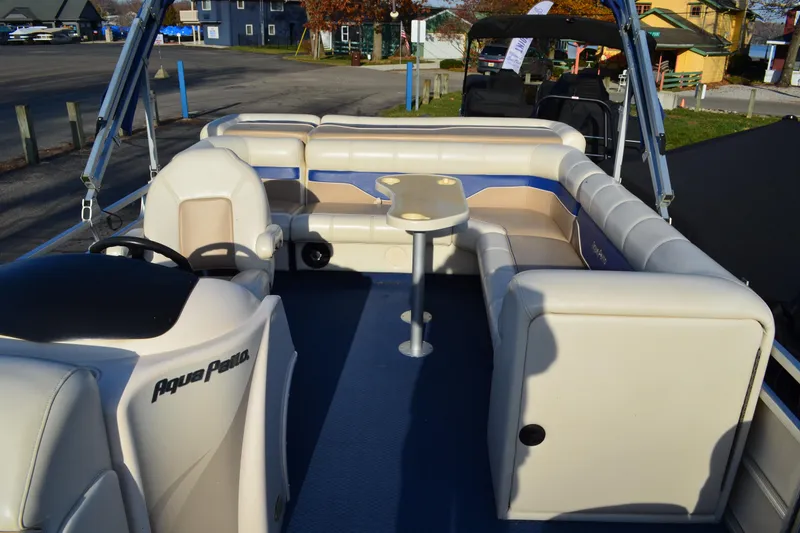 Slide: The Image of 2004 AquaPatio 22 pontoon boat interior with seating and steering console. - 12
