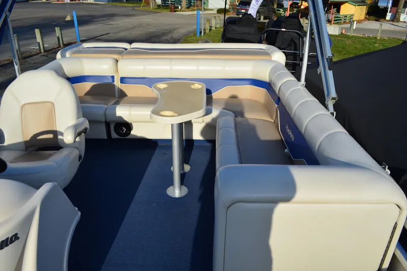 Slide: The Image of 2004 AquaPatio 22 boat interior with cushioned seating and table. - 13