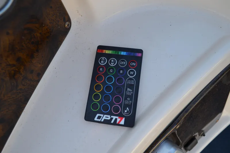 Slide: The Image of Remote control on AquaPatio 22 boat, 2004 model, featuring colorful buttons and lighting options. - 19