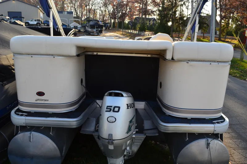 Slide: The Image of 2004 AquaPatio 22 pontoon boat with Honda 50 outboard motor, parked outdoors. - 6