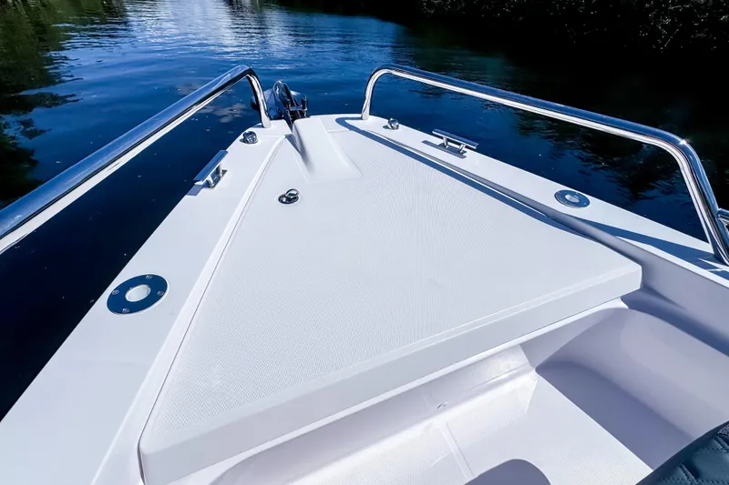 Slide: The Image of 2024 Axopar 37 Sun Top boat deck with sleek design and stainless steel railings. - 29