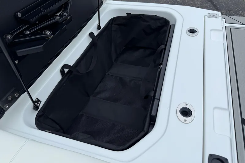 Slide: The Image of 2026 Moomba Max boat storage compartment with black interior and secure latches. - 11