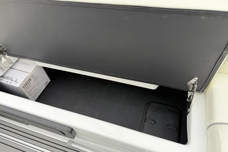 Slide: The Image of Open storage compartment in 2026 Moomba Max boat with marine equipment. - 15