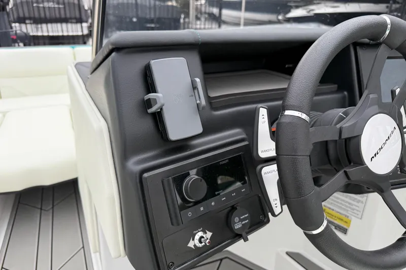 Slide: The Image of 2026 Moomba Max boat dashboard with steering wheel and control panel. - 24