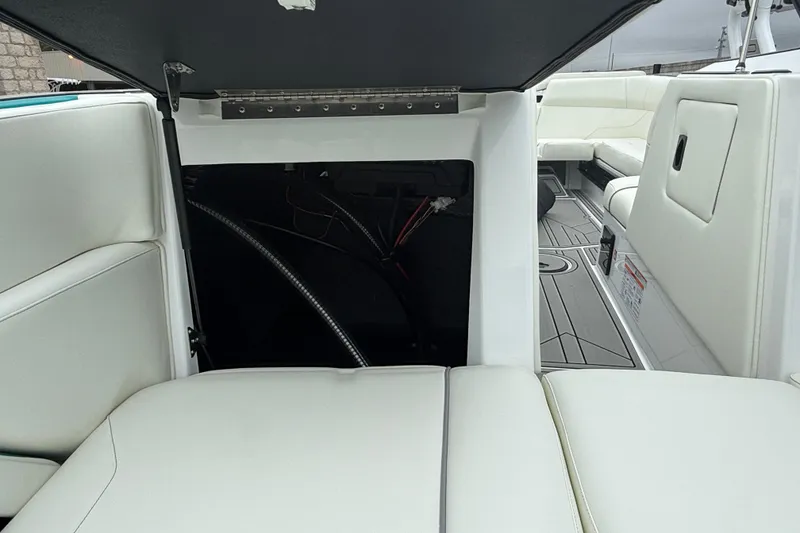 Slide: The Image of 2026 Moomba Max boat interior with open storage compartment and white seating. - 28