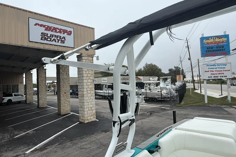 Slide: The Image of 2026 Moomba Max boat at dealership with Supra Boats signage in Texas. - 30