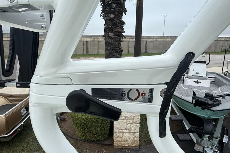 Slide: The Image of 2026 Moomba Max boat tower lock mechanism with handle and lock indicators. - 31