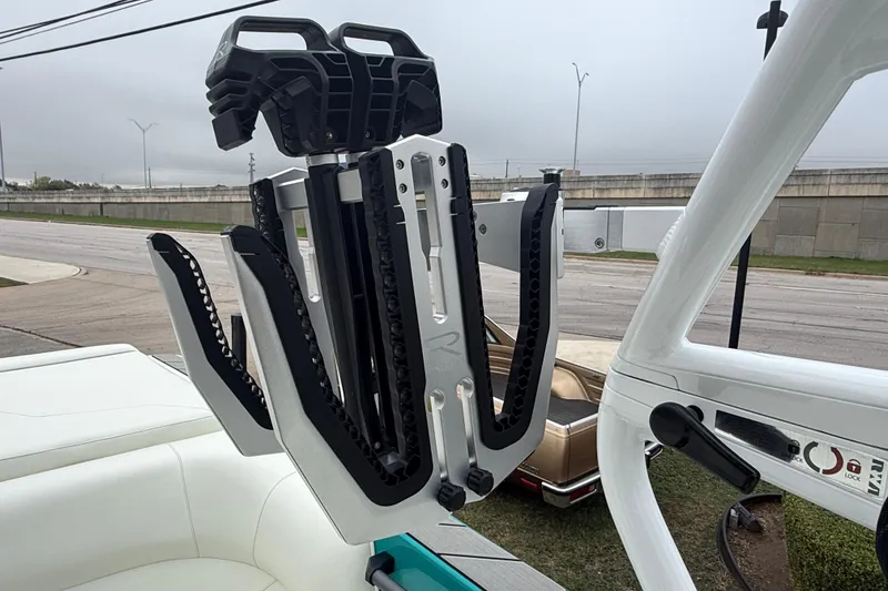 Slide: The Image of 2026 Moomba Max boat with advanced wakeboard rack on a cloudy day. - 33