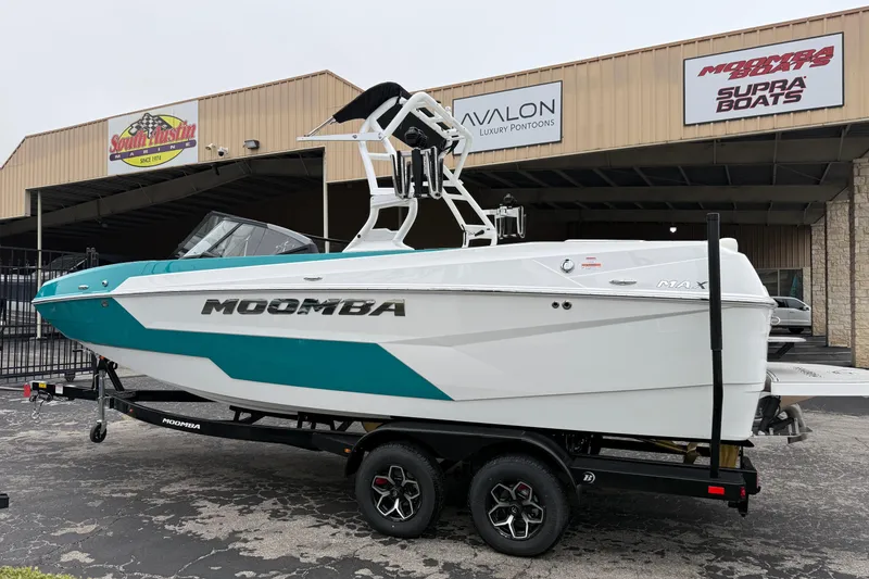 Slide: The Image of 2026 Moomba Max boat on trailer at dealership, featuring sleek design and vibrant colors. - 4