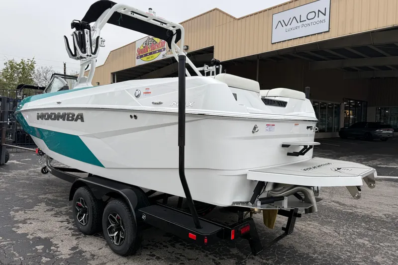 Slide: The Image of 2026 Moomba Max boat on trailer at Avalon Luxury Pontoons dealership. - 5