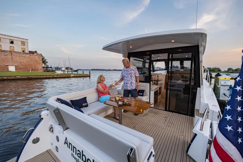 Slide: The Image of Couple enjoying leisure time on 2025 MJM 42 yacht, docked by scenic waterfront. - 15