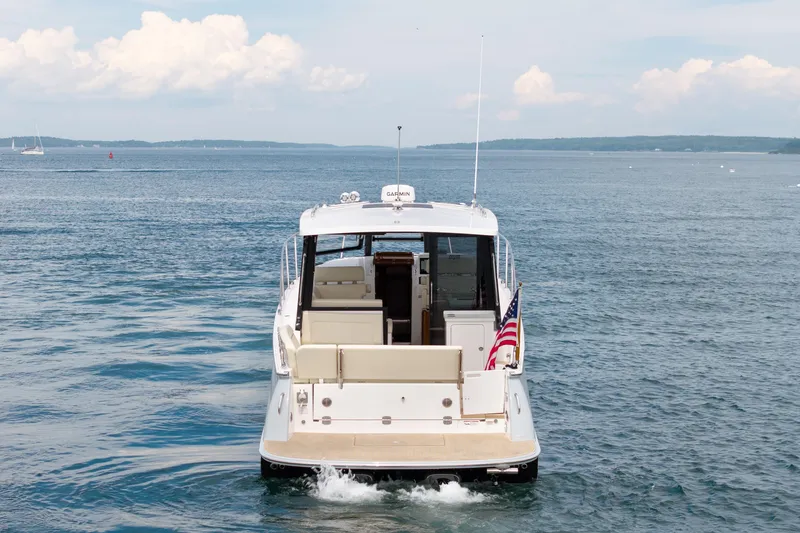 Slide: The Image of 2025 MJM 42 yacht cruising on open water with American flag. - 3