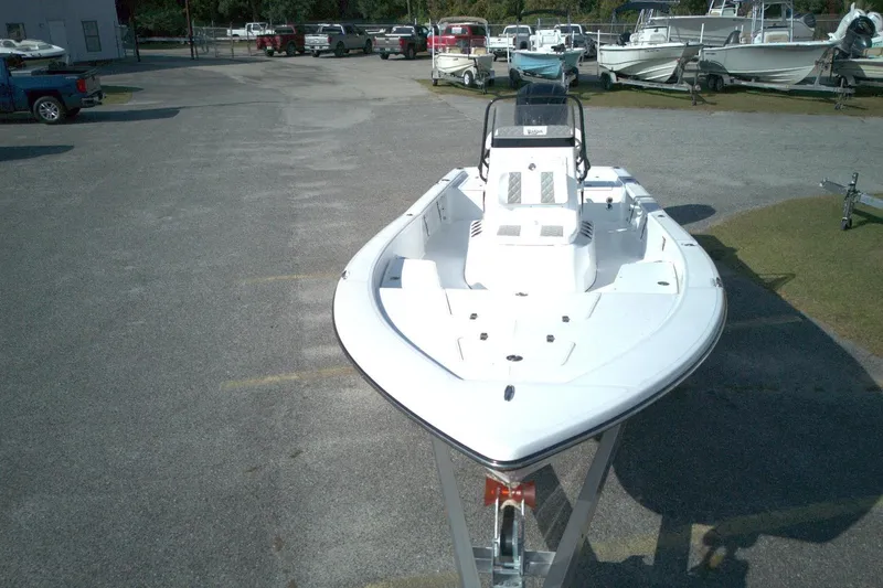 Slide: The Image of 2026 BlackJack 224 boat on trailer in parking lot, surrounded by other boats. - 3