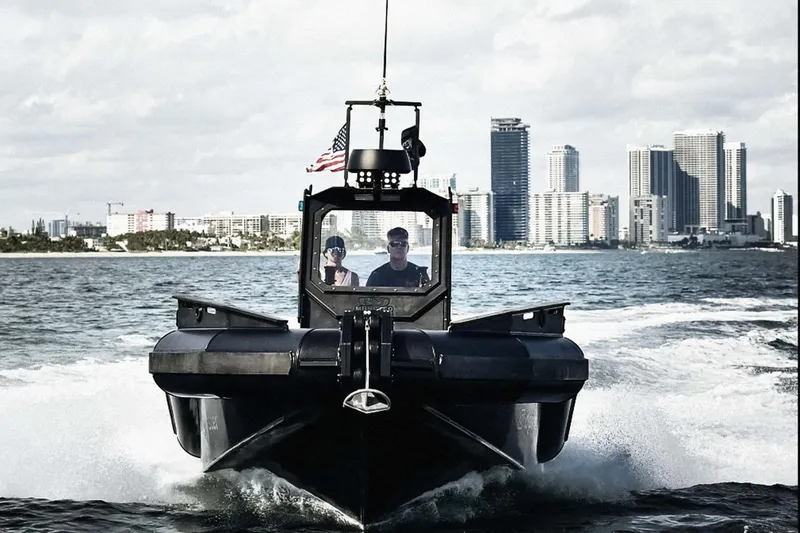 Slide: The Image of DGS 777 Military boat cruising near city skyline, 2022 model. - 5