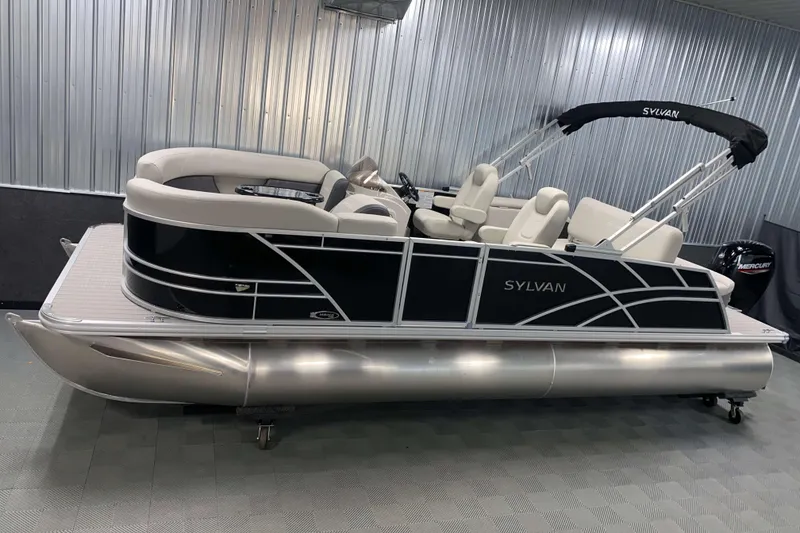 The Image of 2025 Sylvan 8 pontoon boat with sleek black and white design in showroom. - 1