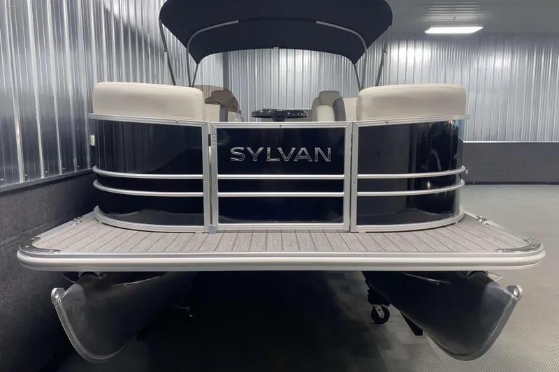 Slide: The Image of 2025 Sylvan 8 pontoon boat in a sleek indoor showroom. - 14