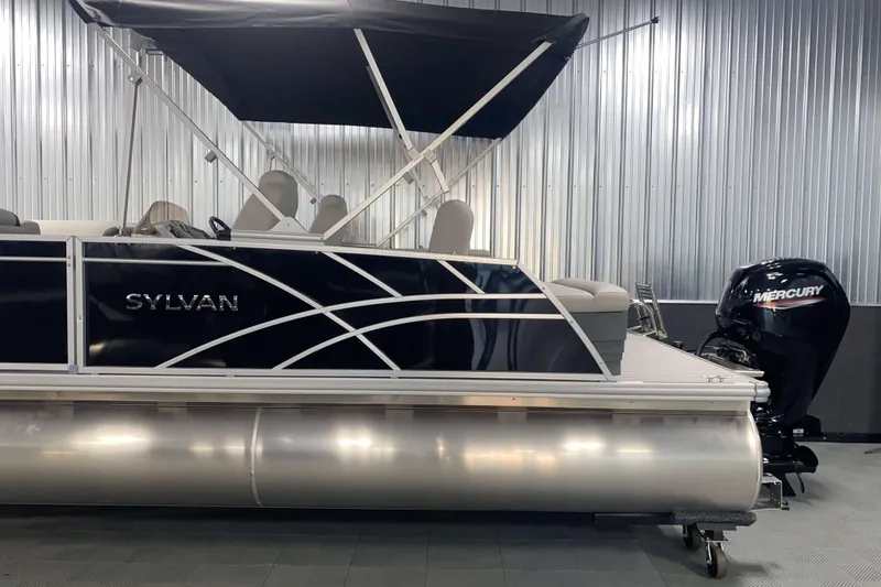 Slide: The Image of 2025 Sylvan 8 pontoon boat with Mercury engine in a showroom. - 18