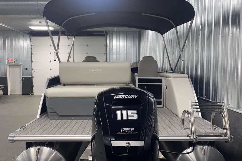 Slide: The Image of 2025 Sylvan 8 boat with Mercury 115 engine in a metal-walled showroom. - 20