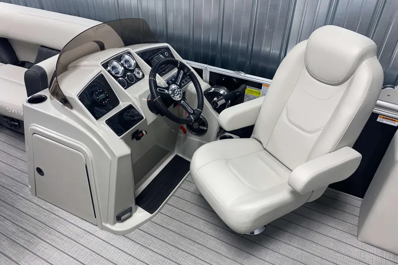 Slide: The Image of 2025 Sylvan 8 boat cockpit with modern steering and plush captain's chair. - 7