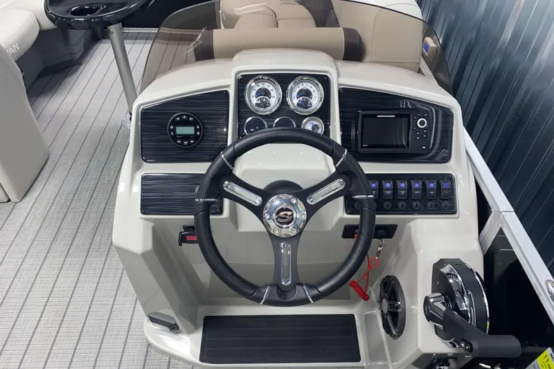 Slide: The Image of 2025 Sylvan 8 boat dashboard with steering wheel and control panel. - 9