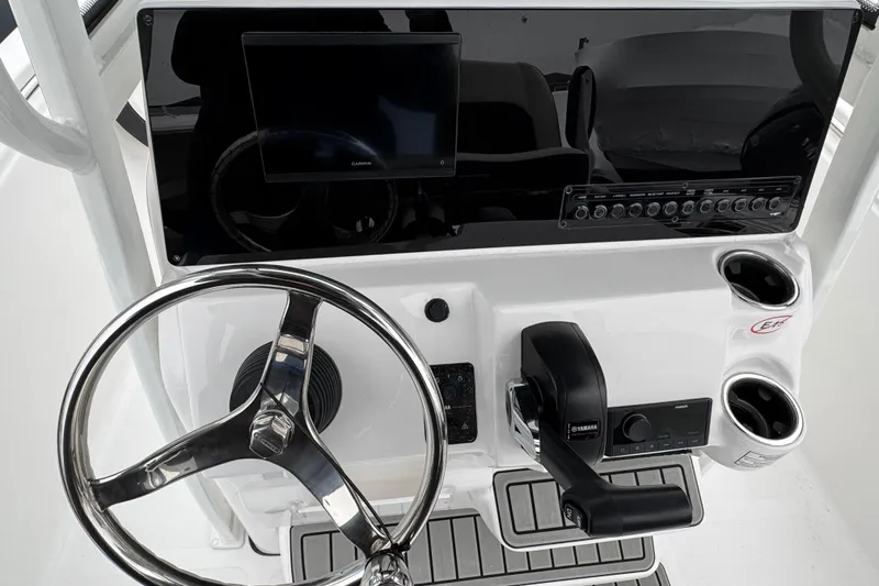 Slide: The Image of 2026 Tidewater 198 CC Adventure boat console with steering wheel and controls. - 10