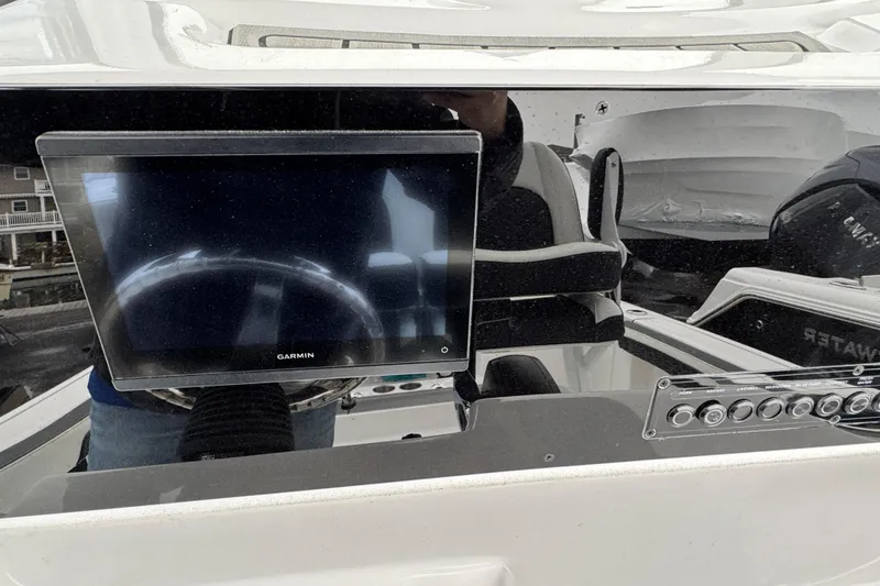 Slide: The Image of 2026 Tidewater 198 CC Adventure boat dashboard with Garmin display and controls. - 11