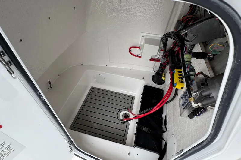 Slide: The Image of 2026 Tidewater 198 CC Adventure boat interior wiring and storage compartment. - 16