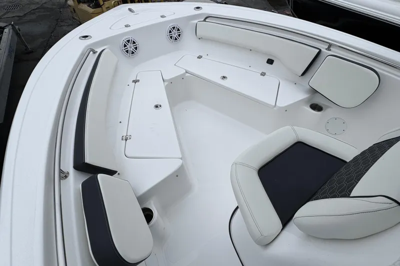 Slide: The Image of 2026 Tidewater 198 CC Adventure boat interior with cushioned seating and storage compartments. - 17