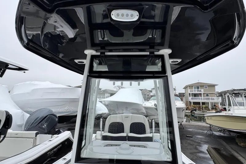 Slide: The Image of 2026 Tidewater 198 CC Adventure boat at marina, showcasing console and seating. - 22