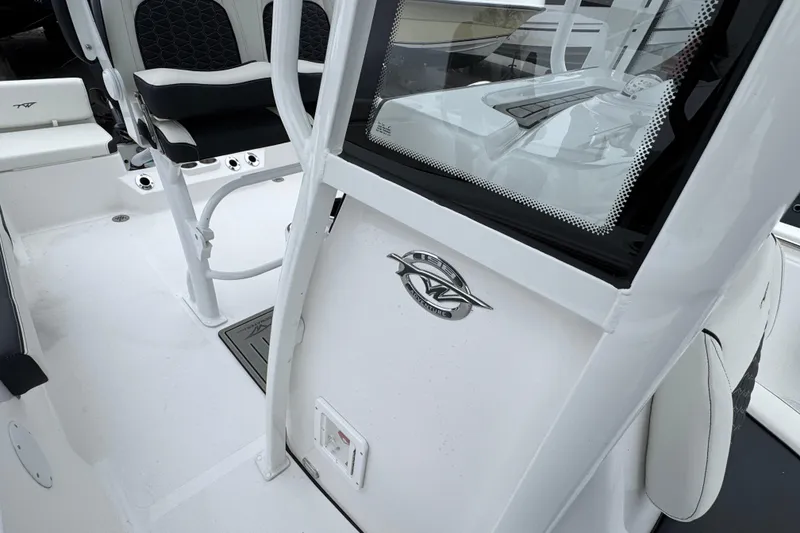 Slide: The Image of 2026 Tidewater 198 CC Adventure boat interior with seating and console details. - 23