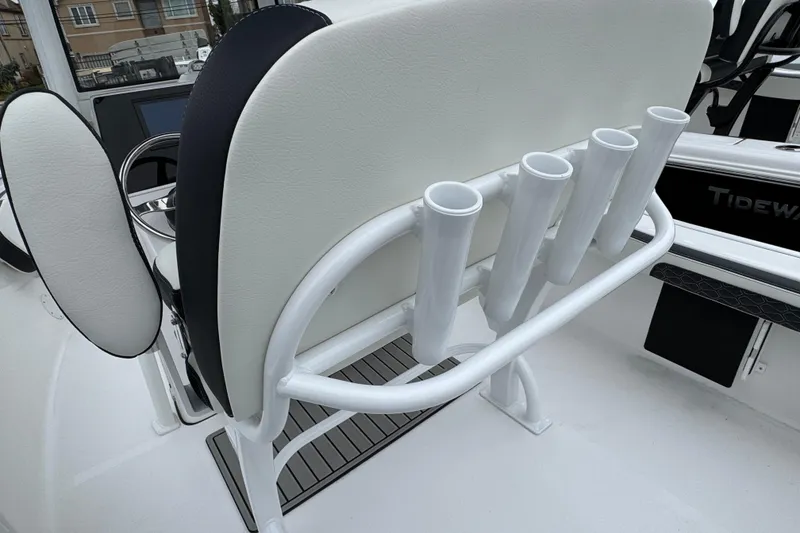 Slide: The Image of 2026 Tidewater 198 CC Adventure boat interior with rod holders and seating. - 4