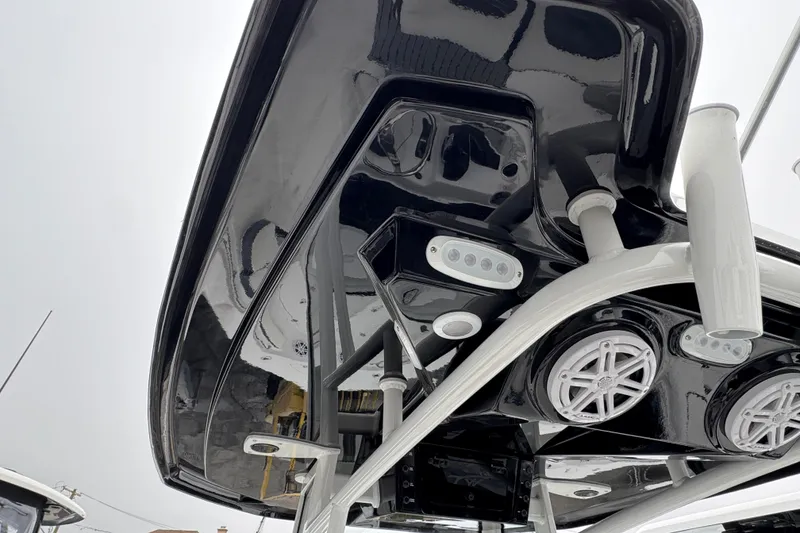 Slide: The Image of 2026 Tidewater 198 CC Adventure boat's sleek black T-top with integrated speakers and lights. - 7