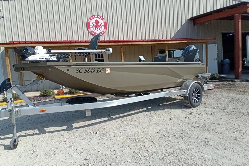 Slide: The Image of 2025 Thor 1754 Timber Hammer boat on trailer outside a building. - 13