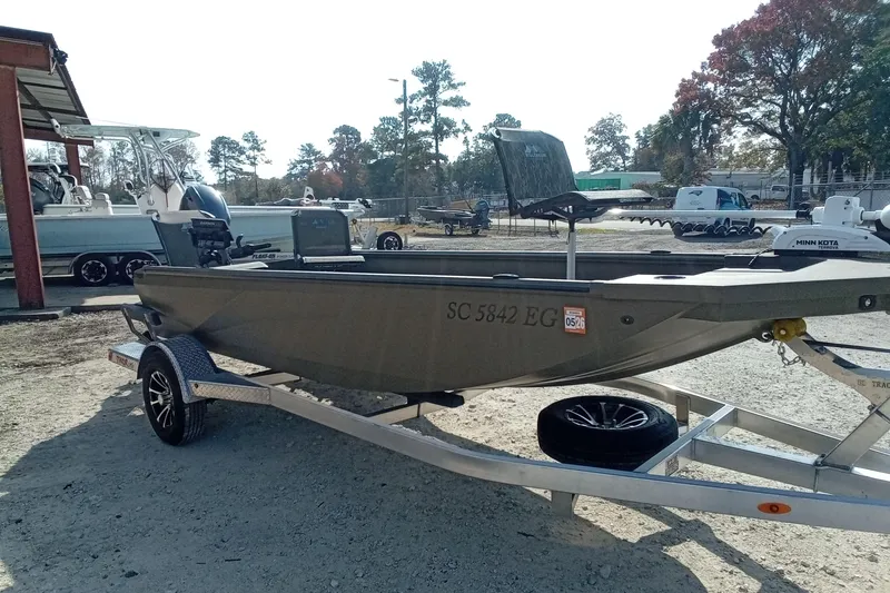 Slide: The Image of 2025 Thor 1754 Timber Hammer boat on trailer, parked outdoors. - 3