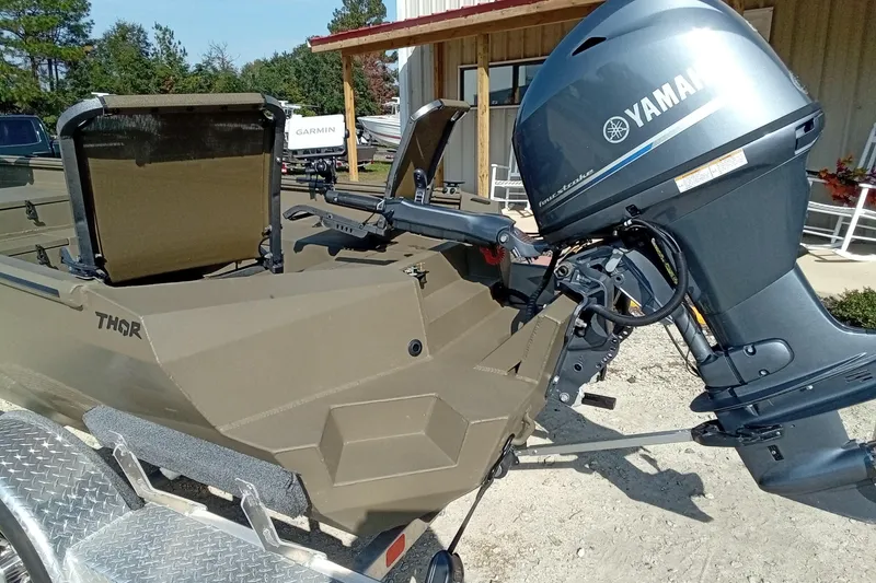 Slide: The Image of 2025 Thor 1754 Timber Hammer boat with Yamaha outboard motor, parked on a trailer. - 9