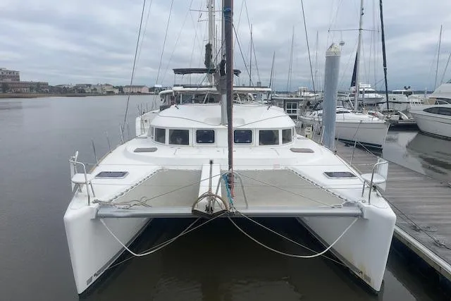 The Image of 2014 Lagoon 380 S2 catamaran docked at a marina, front view. - 0