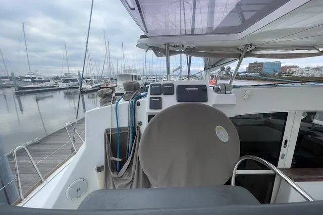 Slide: The Image of 2014 Lagoon 380 S2 catamaran deck view at marina. - 16