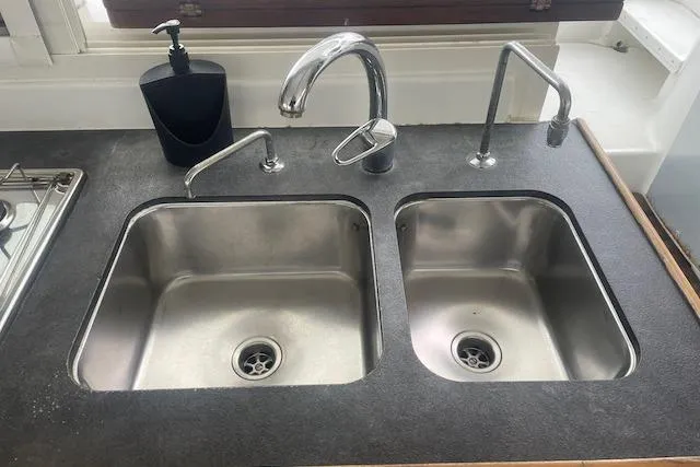 Slide: The Image of Deck view of 2014 Lagoon 380 S2 yacht with dock in background. - 24